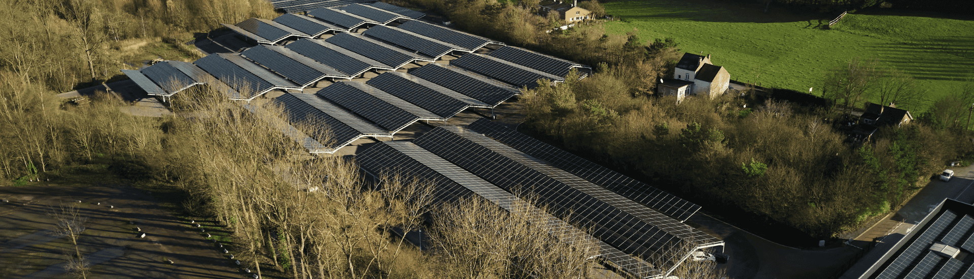 Aerial view of a large building featuring solar panels on its roof