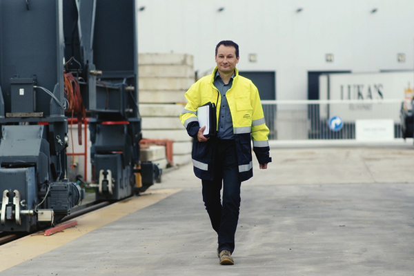 ENGIE employee wearing fluorescent jacket and carrying a binder