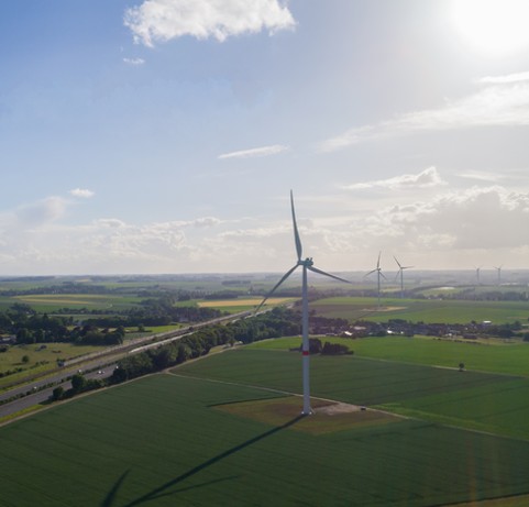 Wind turbines in a field along the highway